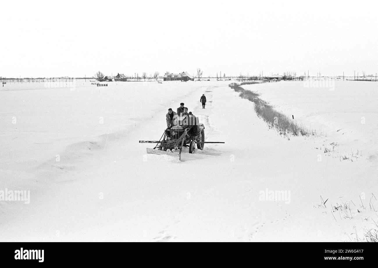 Friesland is preparing for the Elfstedentocht, between Berlikum and St. Annaparochie with an agricultural tractor on the ice ca. January 14, 1963 Stock Photo