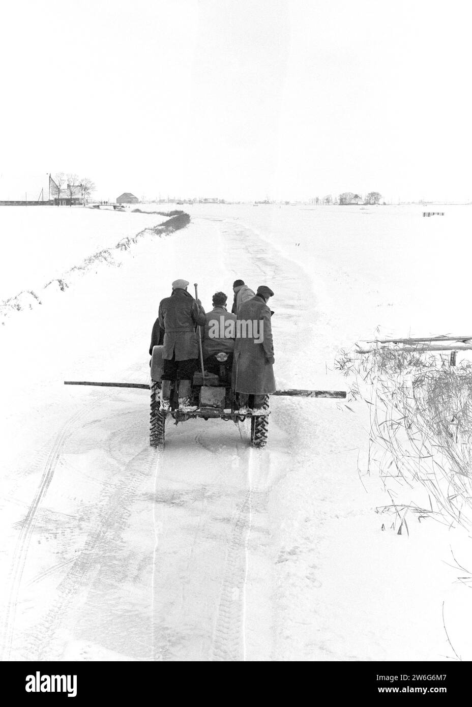 Friesland is preparing for the Elfstedentocht, between Berlikum and St. Annaparochie with an agricultural tractor on the ice ca. January 14, 1963 Stock Photo