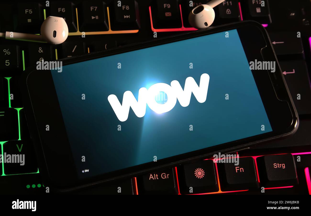 Viersen, Germany - December 9. 2023: Closeup of smartphone on computer keyboard with logo lettering of wow streaming service Stock Photo
