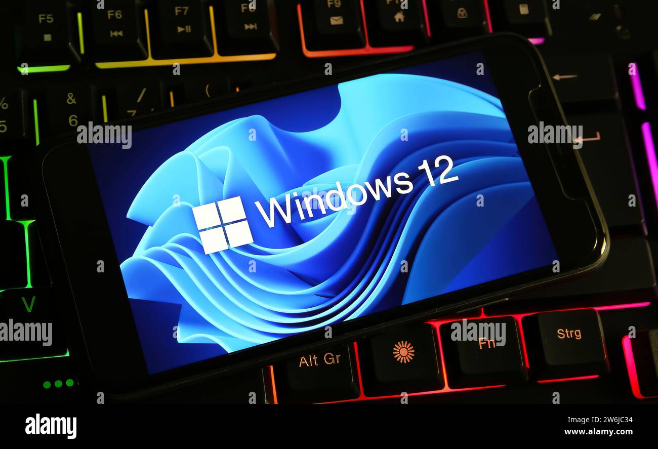 Viersen, Germany - December 9. 2023: Closeup of smartphone on computer keyboard with logo lettering of Microsoft windows 12 Stock Photo