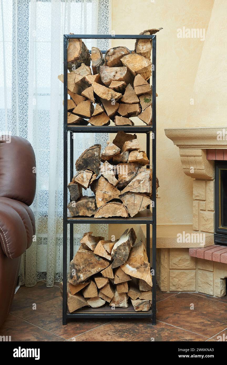 A rack with firewood for the fireplace in the living room Stock Photo