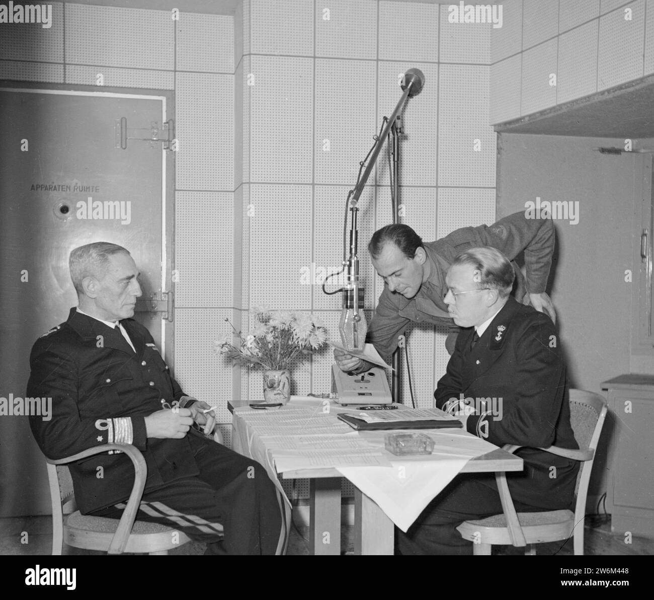 Naval officers preparing for a radio broadcast ca. undated Stock Photo