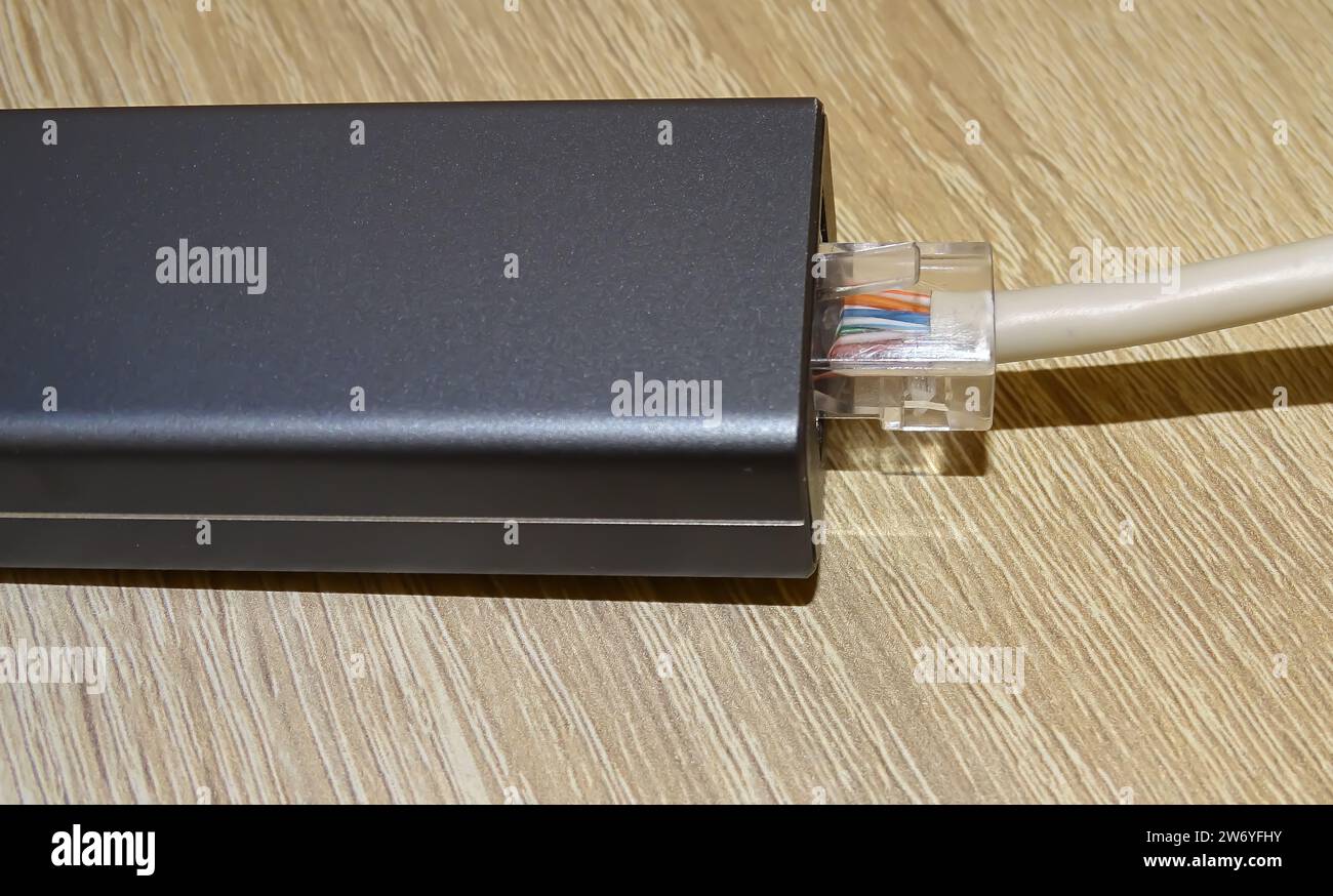Internet cable connected to a multi-functional USB-C Hub station, Ethernet Stock Photo
