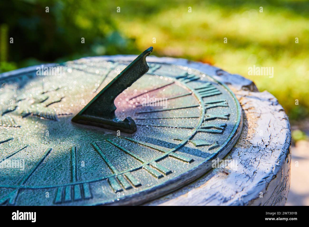 Vintage Sundial in Garden with Morning Dew, CloseUp Perspective Stock