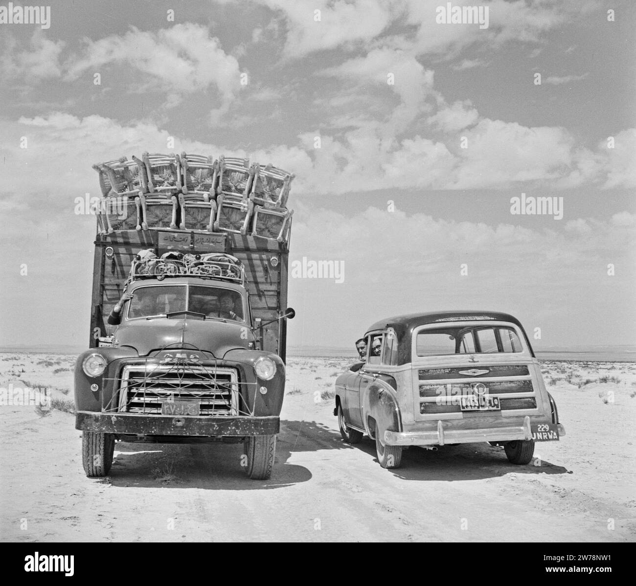Car and truck driving in the desert on the road from Malula to Damascus