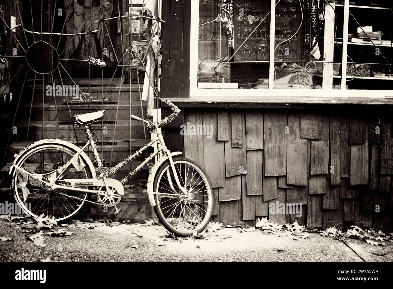 Old bicyle propped up beside an building Stock Photo