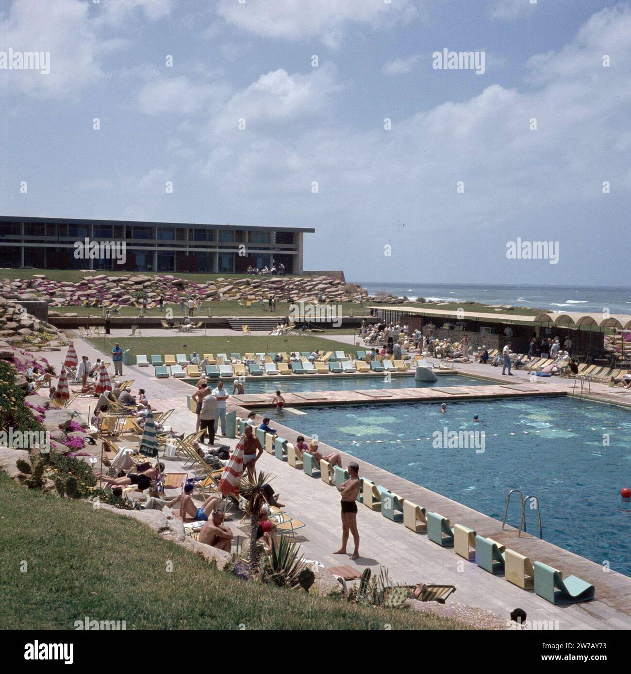 Herzlia. Hotel Accadia: view of the outdoor swimming pool, the sun terraces and a wing of the hotel with the waves of the Mediterranean Sea on the right ca. undated Stock Photo