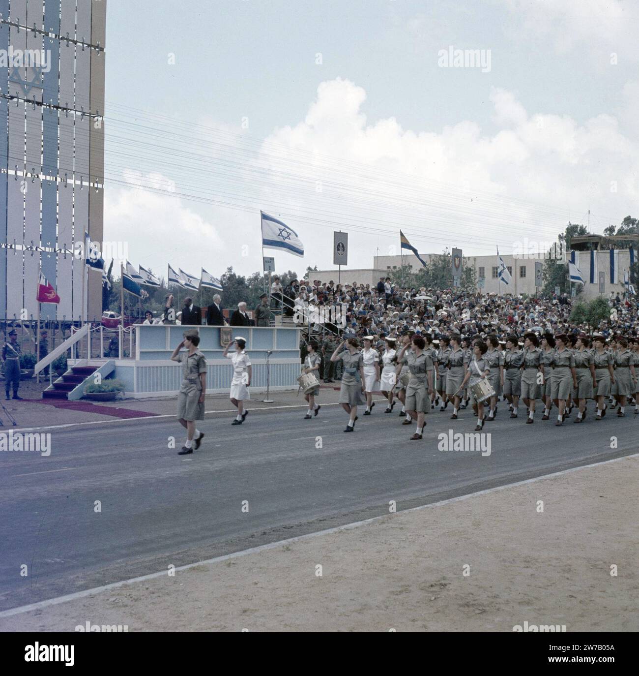 Military parade on the occasion of Independence Day (May 15). Department of women naval personnel passes the grandstand on which prominent figures, including Israeli President Ben Zvi and Prime Minister Ben Gurion, conduct the parade ca. 1964 Stock Photo
