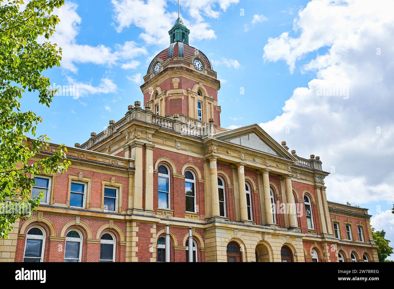 Front of Elkhart County courthouse on blue sky day with fluffy white