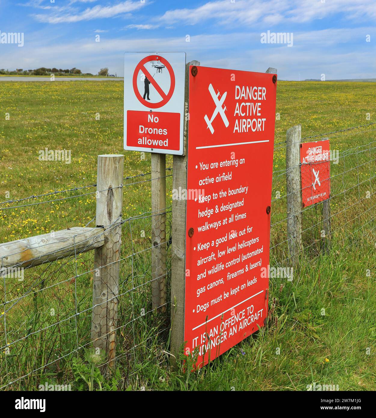 A warning sign saying 'danger - active airport' at Land's End Airport, St. Just, Cornwall, England, UK Stock Photo