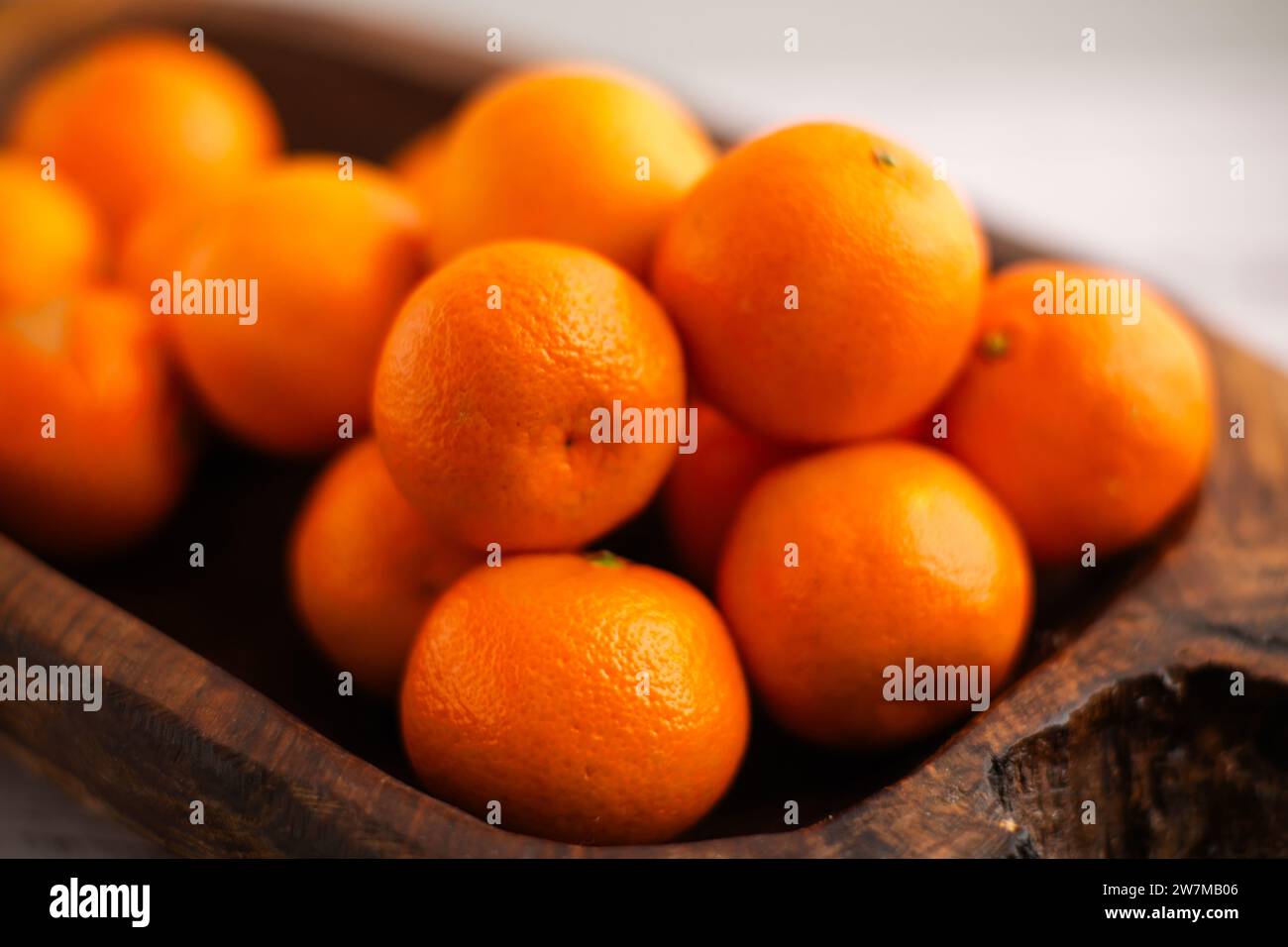 Citrus bounty Mandarins resting in a wooden dish, a vitaminpacked