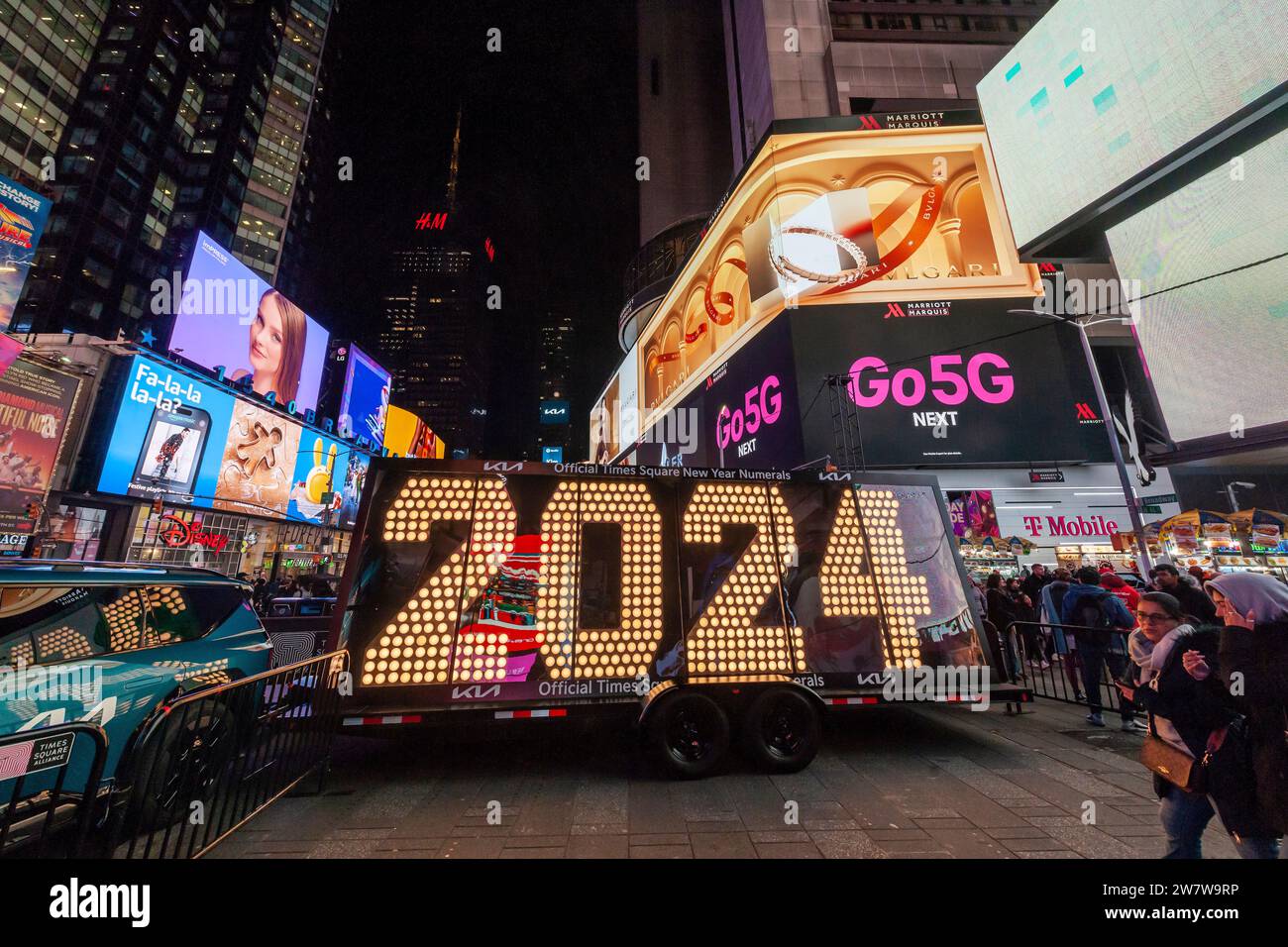 Visitors to Times Square in New York flock to the temporary display of the “2024” numbers on Wednesday, December 20, 2023 . The “2024” is the led display atop One Times Square lighting up at midnight January 1 ushering in the New Year. The seven-foot tall numbers will remain until Friday when they will be moved to their proper location.  (© Richard B. Levine) Stock Photo