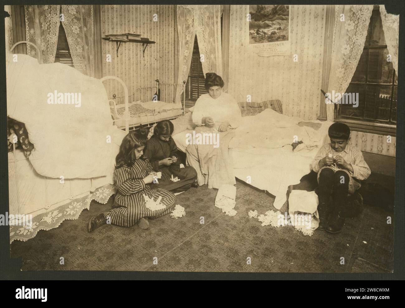 Witness F. A. Smith. Home of Sarkis Bedrosian, 7 Elizabeth St., Worcester, Mass. Children 6 yrs., 8 yrs., 10 yrs. and mother. Earn about $1.50 a week working on garter buttons. Father earns Stock Photo