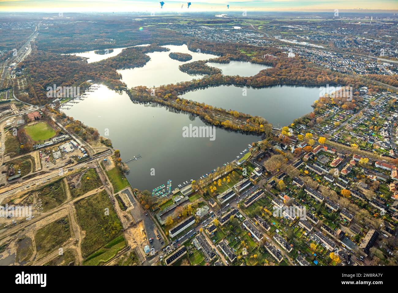 Aerial view, Sechs-Seen-Platte, recreation area, distant view with smoking cooling towers, surrounded by autumnal deciduous trees, Wedau, Duisburg, Ru Stock Photo