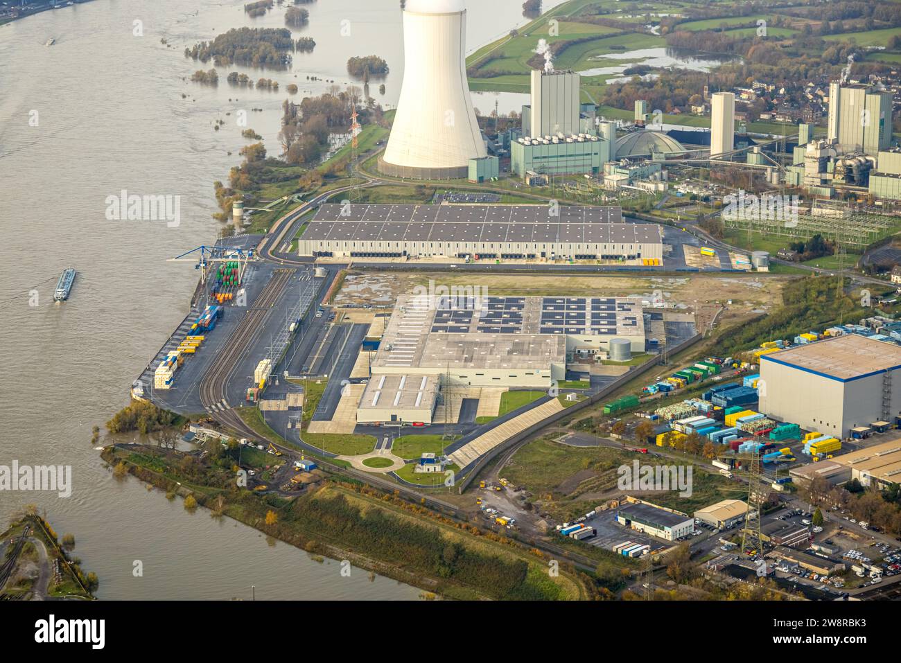 Aerial view, logport VI (Six) industrial area logistics services, STEAG power plant Walsum with smoking cooling tower on the river Rhine with high wat Stock Photo