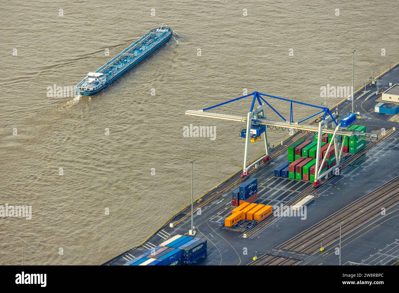 Aerial view, logport VI (Six) industrial area logistics services, inland navigation on the river Rhine with container loading area, surrounded by autu Stock Photo