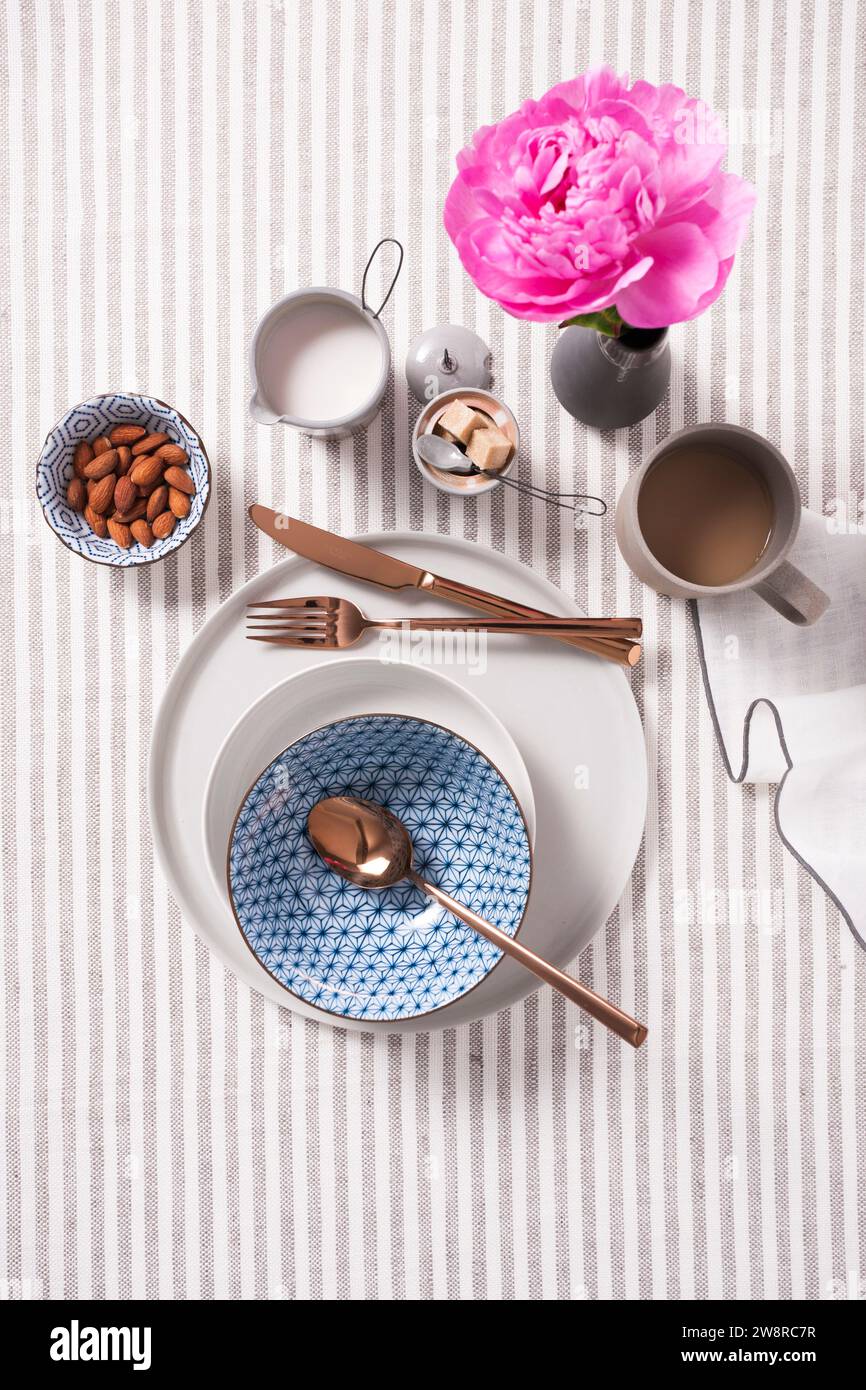 High angle view of breakfast table setting on a gray and white striped background Stock Photo