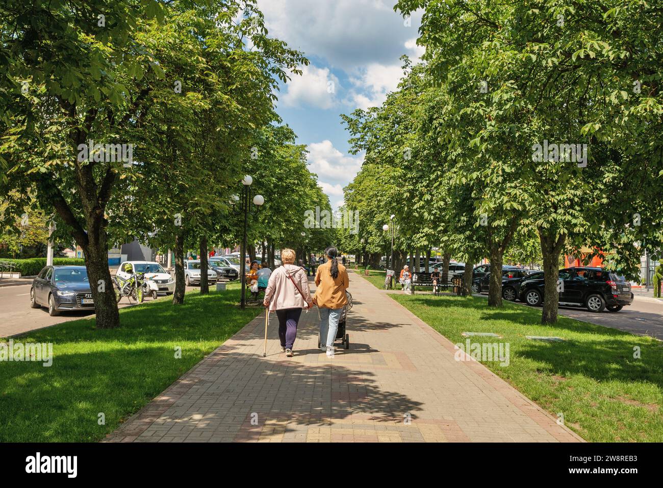 Sarny, Ukraine - June 30, 2023: People walk in park in the city center. Sarny is a small city in Rivne region, western Ukraine. It is a major railway Stock Photo