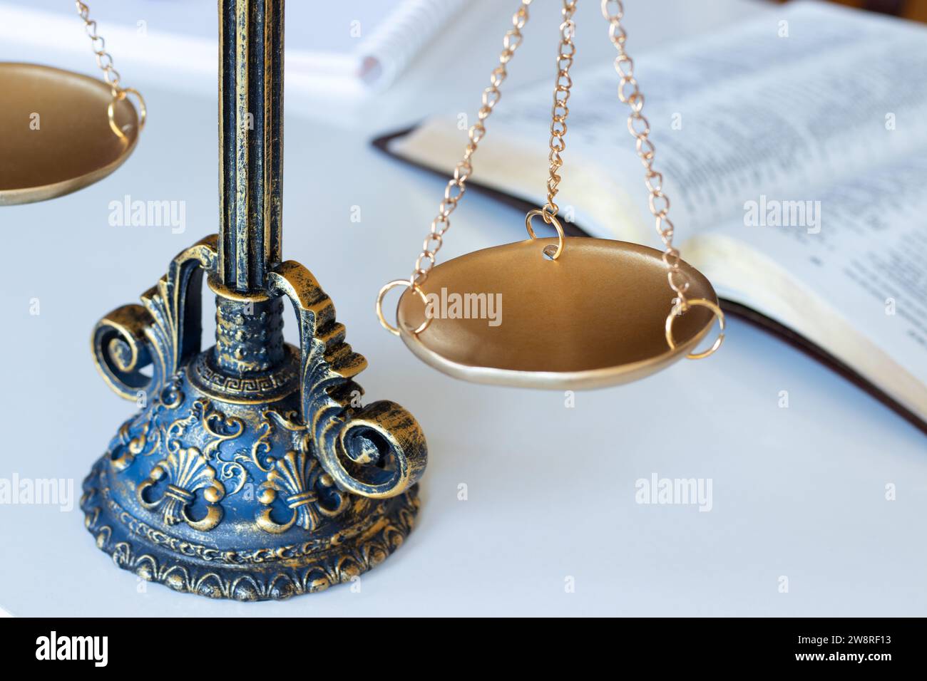 Ancient balance scales on white with holy bible book in the background