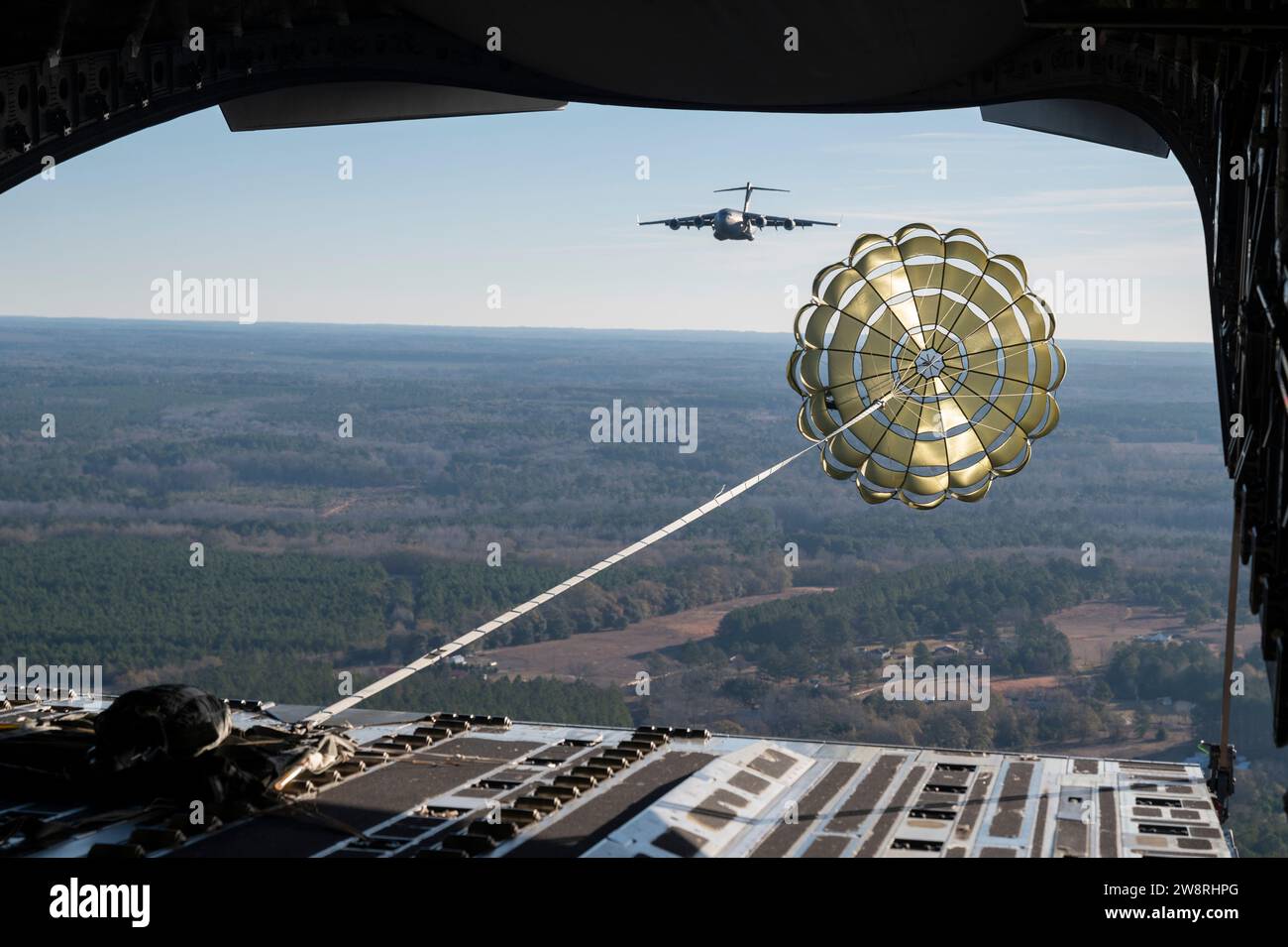 The 15th Airlift Squadron conducts an airdrop over South Carolina, Dec. 14, 2023. The 437th Airlift Wing conducted airdrop training to hone the skills needed to sustain mission excellence. (U.S. Air Force photo by Staff Sgt. Emily Farnsworth) Stock Photo