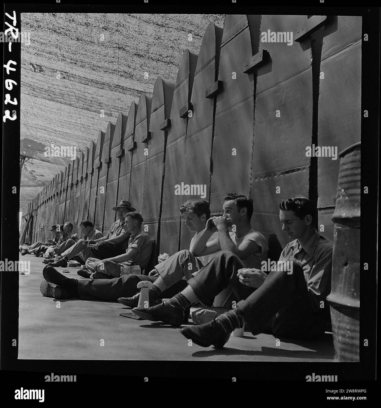 Workers eat lunch against PBY wing panels at Consolidated Vultee