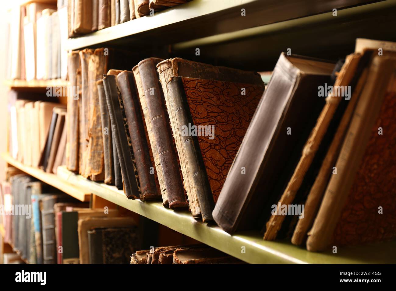 Collection of old books on shelves in library Stock Photo - Alamy