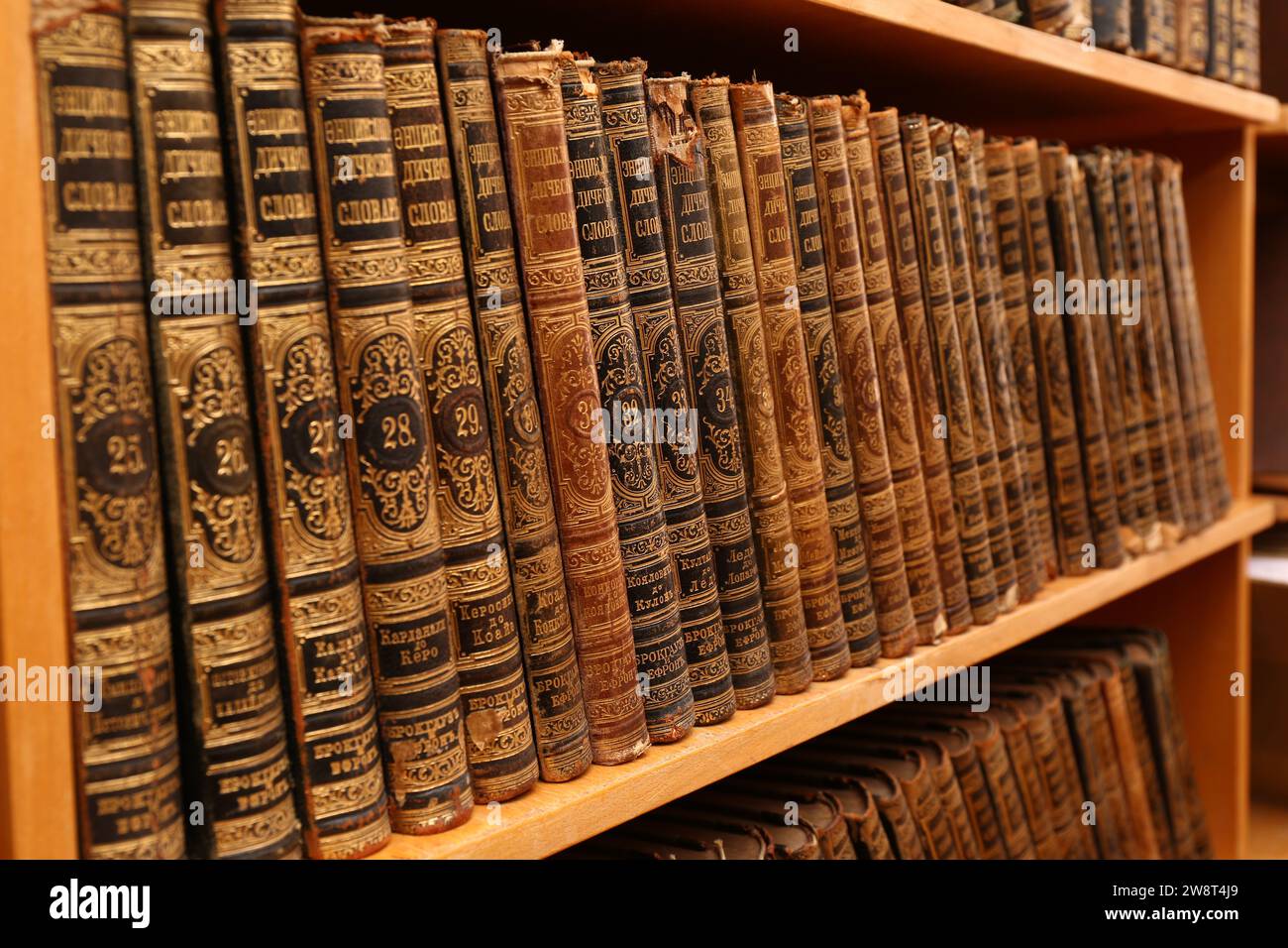 Collection of old books on shelf in library Stock Photo - Alamy