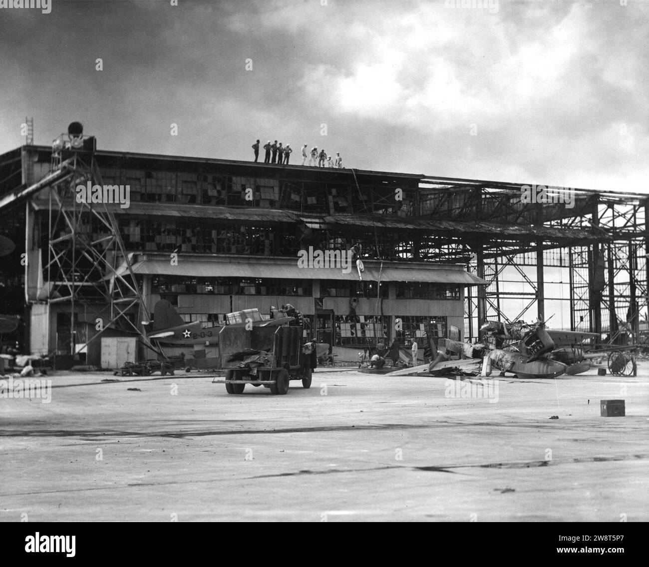 Wrecked hangar at NAS Ford Island with OS2Us 1941. Stock Photo