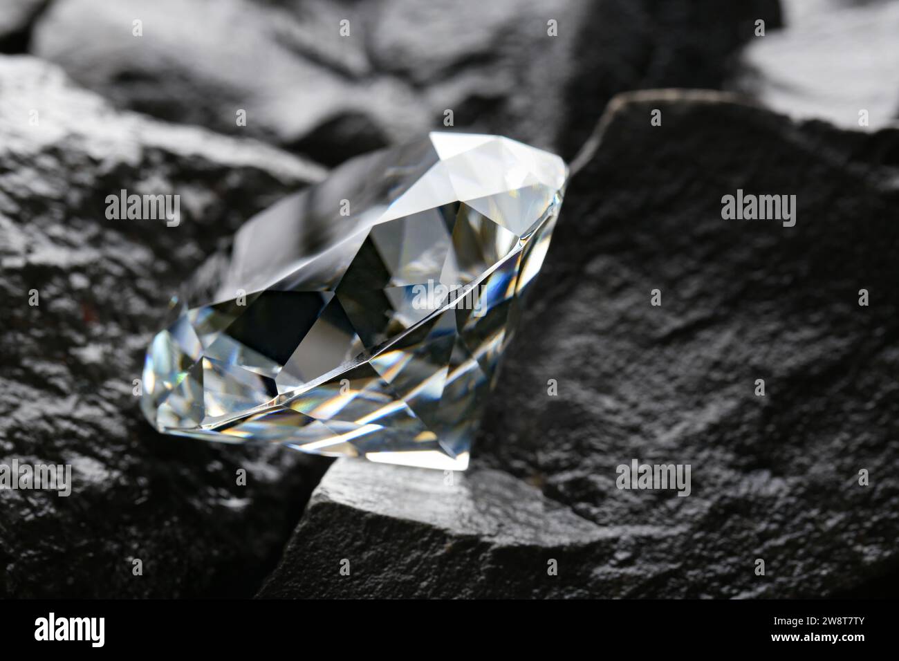 Beautiful shiny diamond on coal, closeup view Stock Photo