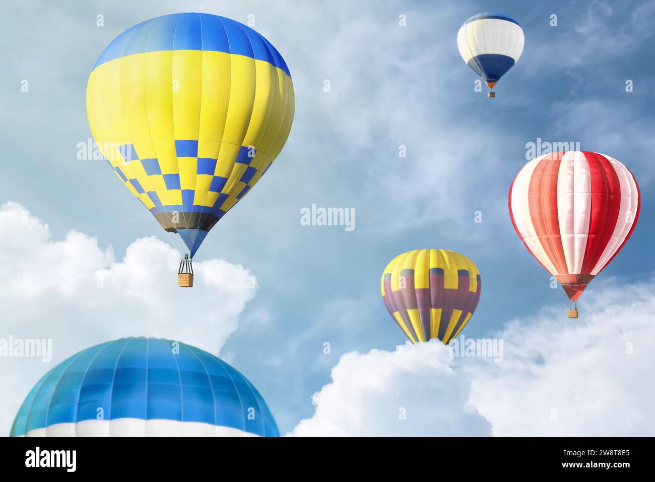 Many bright hot air balloons flying in sky Stock Photo - Alamy