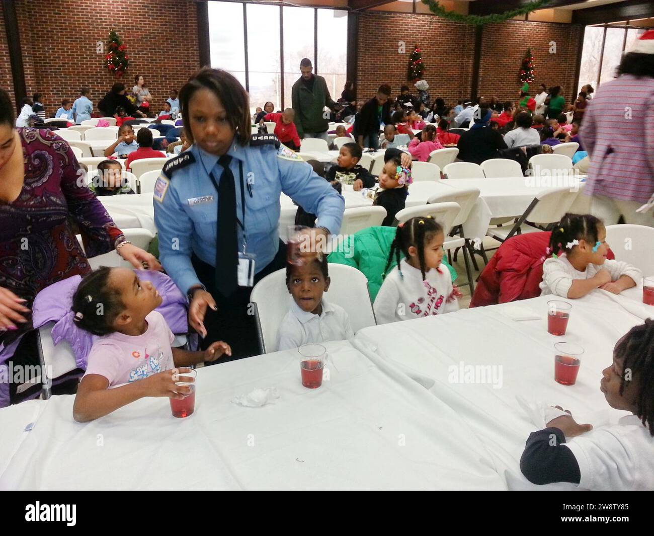 Youth at the DC Ward 8-Metropolitan Police Department (MPD) Seventh District holiday party for underprivileged children look up to a Cadet from the MPD Police Academy 131218 Stock Photo