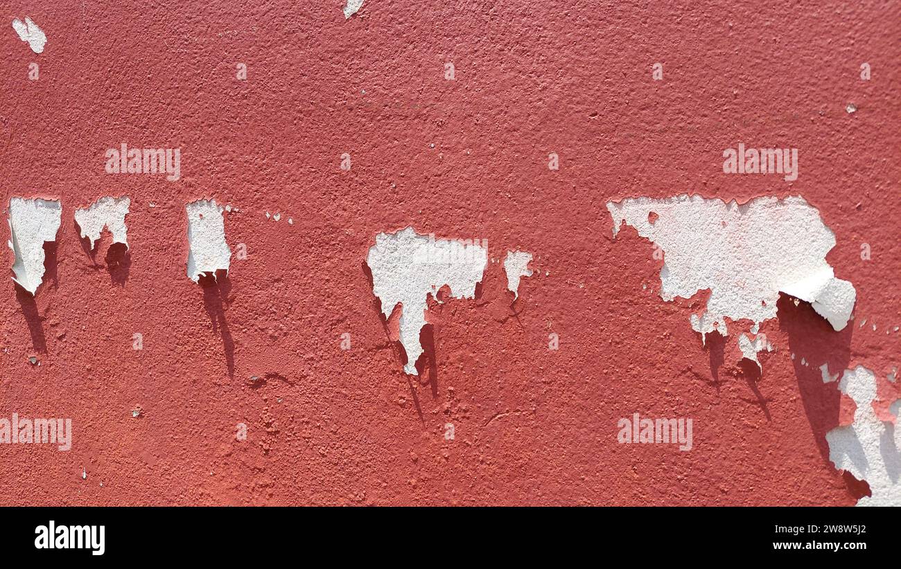 Paint peeling from the red wall Stock Photo