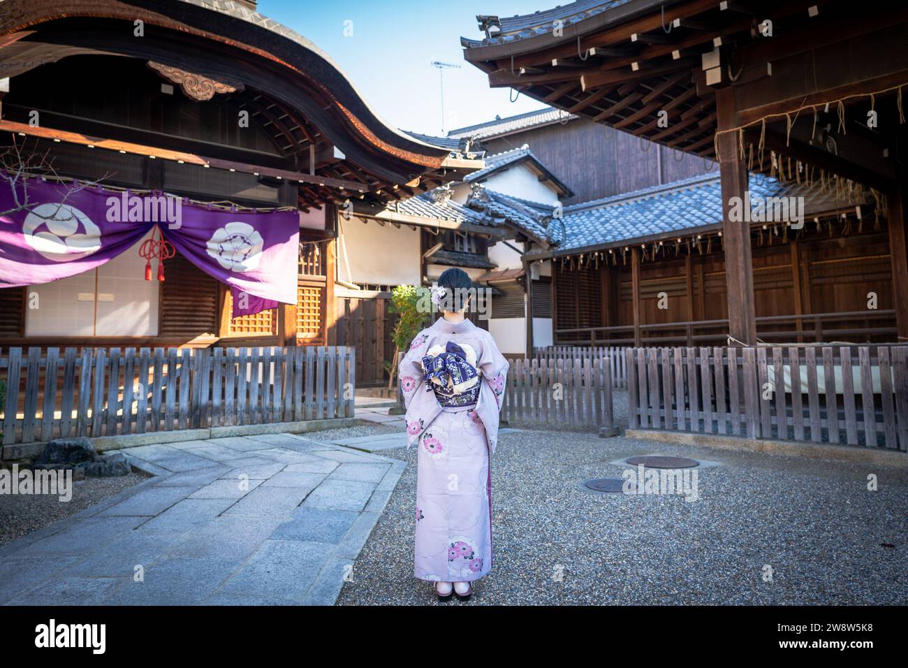 Japanese Kimono Portrait back view photography. Kyoto, Japan. Japanese traditional buildings background Stock Photo