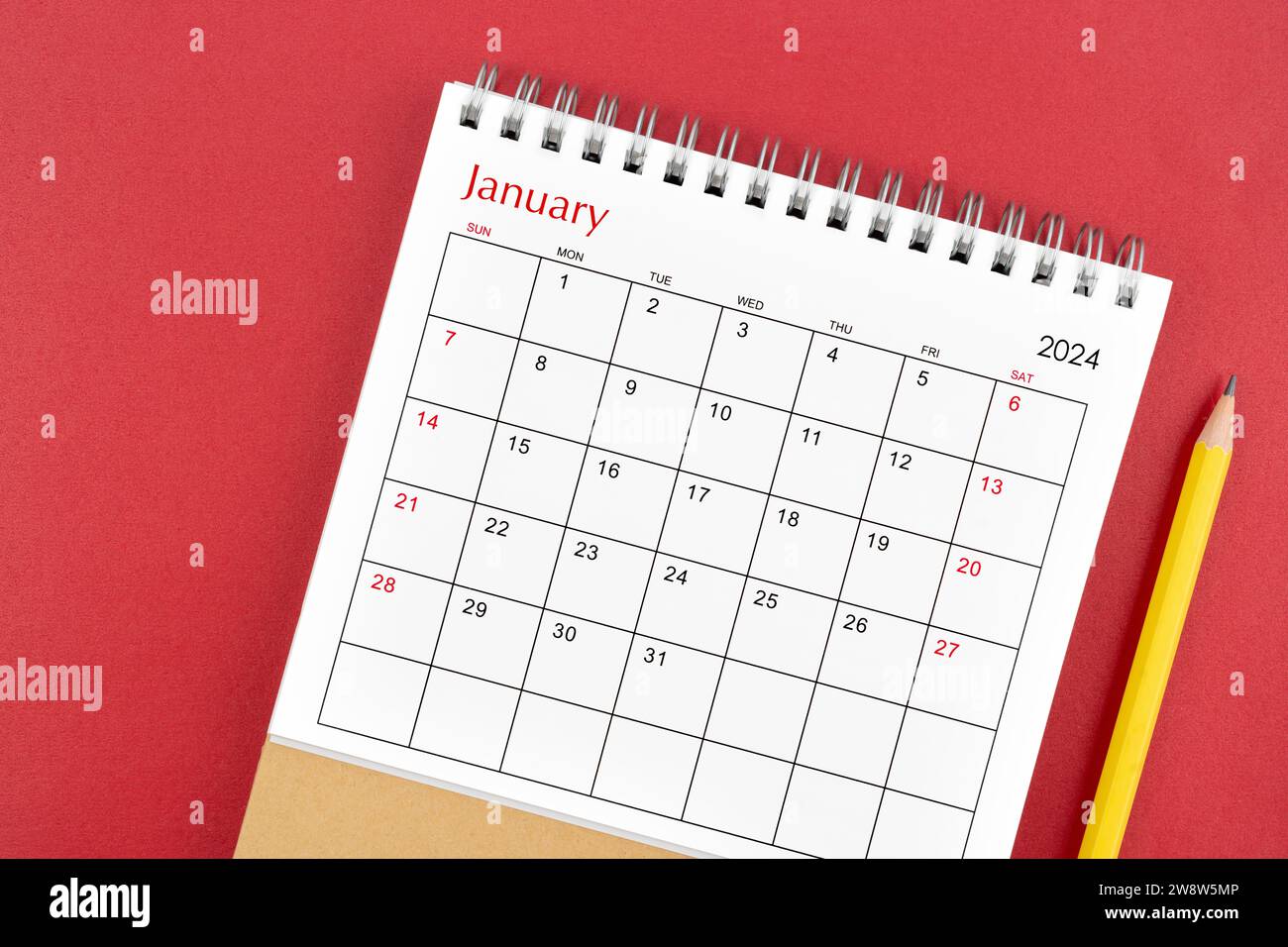January 2024 desk calendar and pencil on red color background Stock ...
