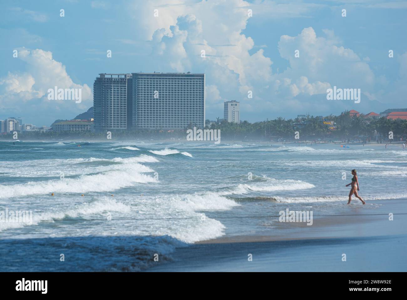 Da Nang, Vietnam - October 4, 2023: waves at beach with hotels and resorts on the horizon. Stock Photo