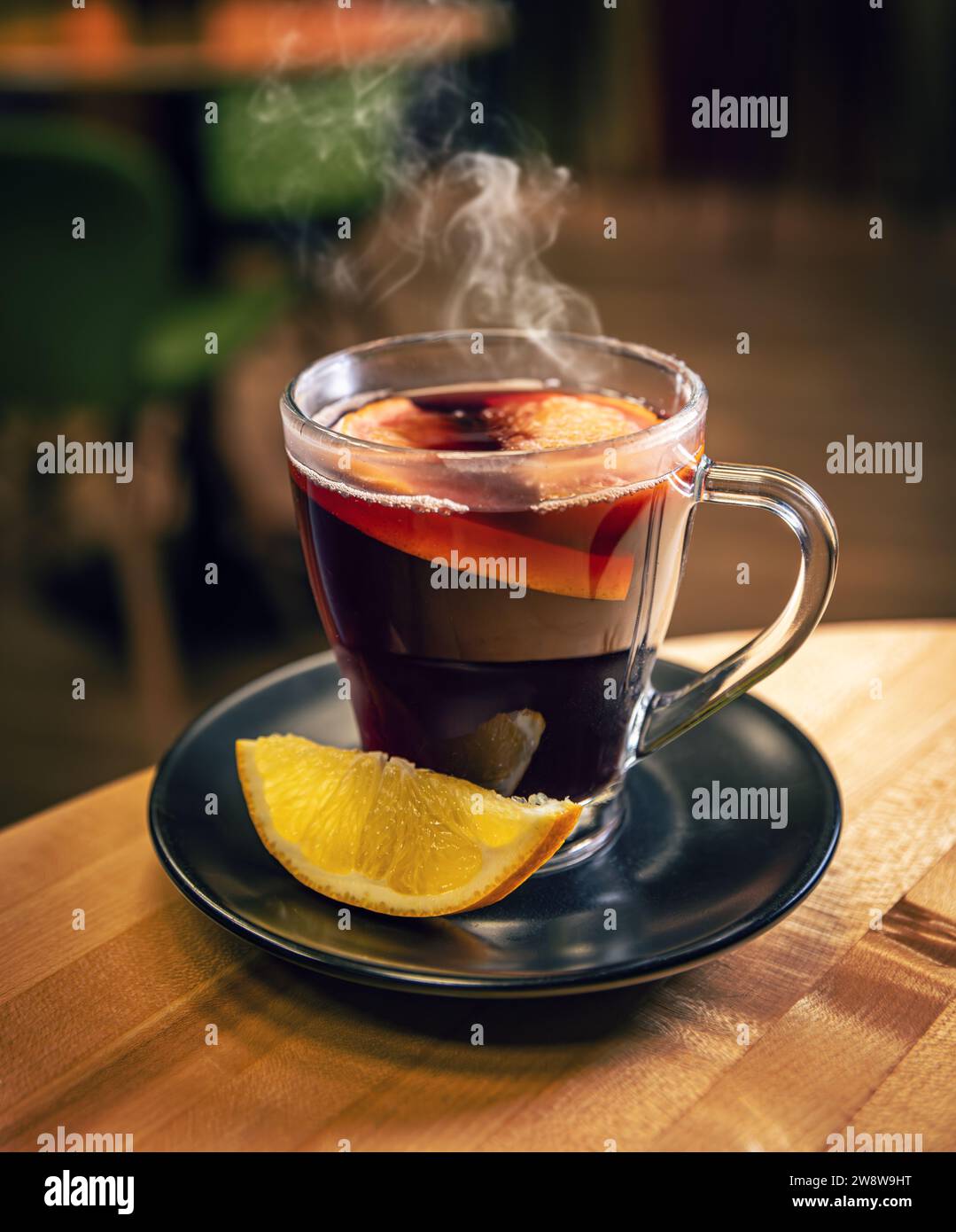 Mulled wine with orange in glasses. Concept of a traditional winter hot drink with spices and fruits for the holiday. Stock Photo
