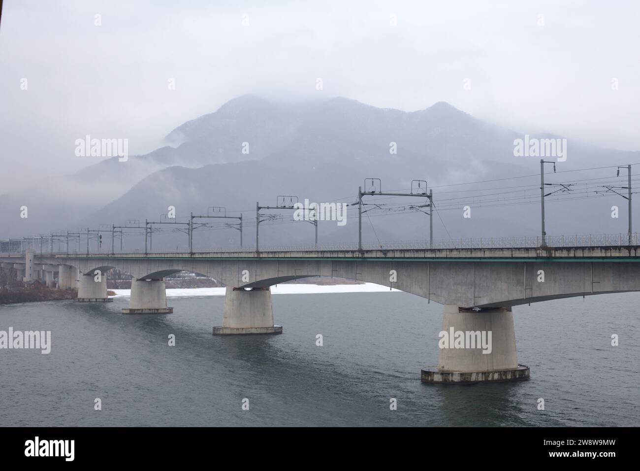 Yangpyeong County, South Korea - February 15, 2020: Amidst winter's embrace, the modernized Yangsu Railway Bridge stands over the North Han River, wit Stock Photo