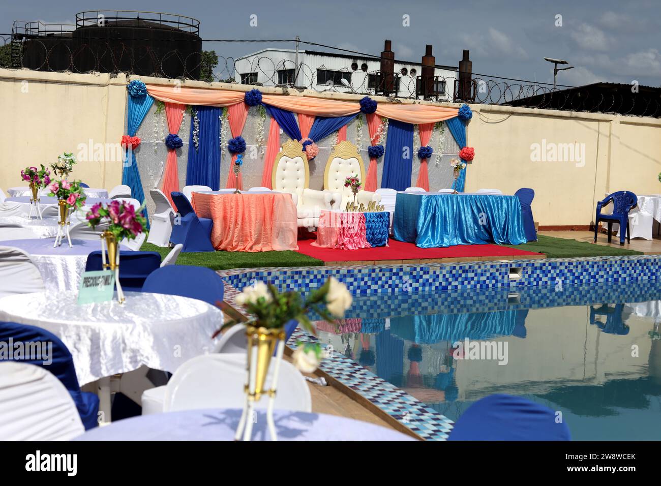 Colourful wedding breakfast party set-up by a pool on a wedding day in Freetown, Sierra Leone, Africa. Stock Photo