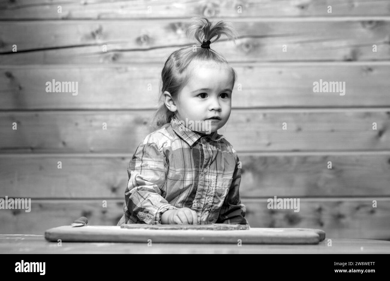 Childrens cook. Little child at kitchen cooking and playing with flour