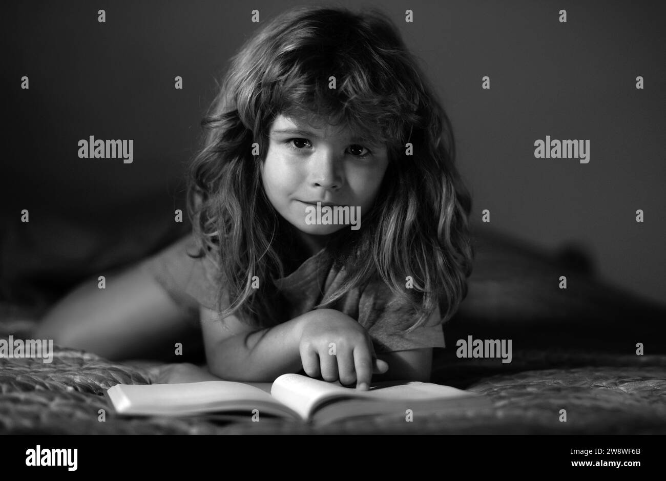 Kids reading books. Child reading a book in bed before going to sleep