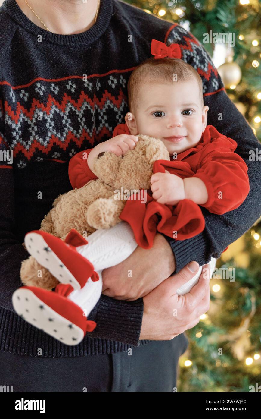 Baby girl enjoys christmas with dad Stock Photo