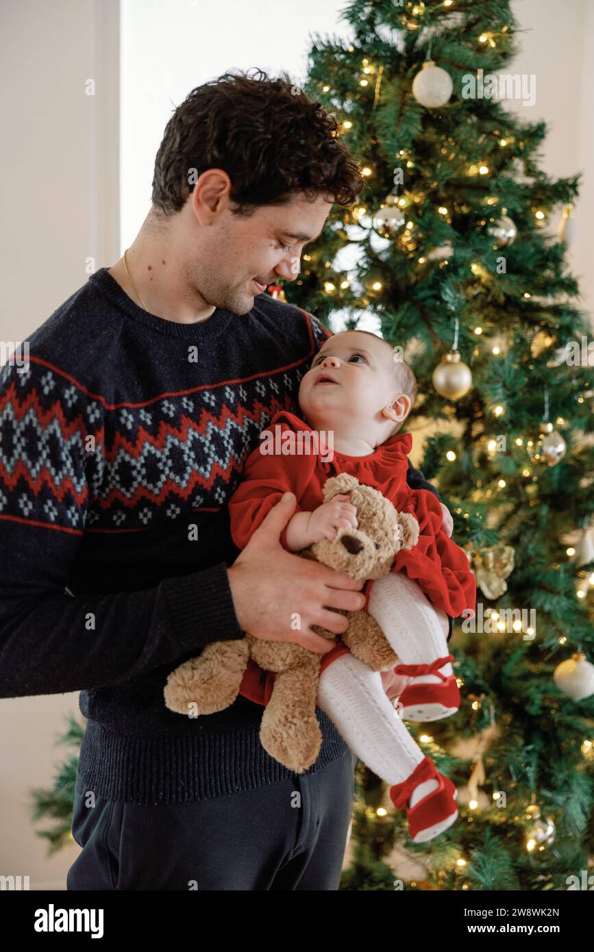 Tender christmas moment between dad and baby Stock Photo