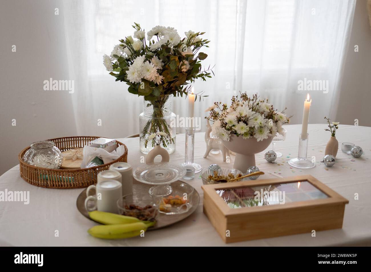 Flowers, tea box and decoration on a table Stock Photo