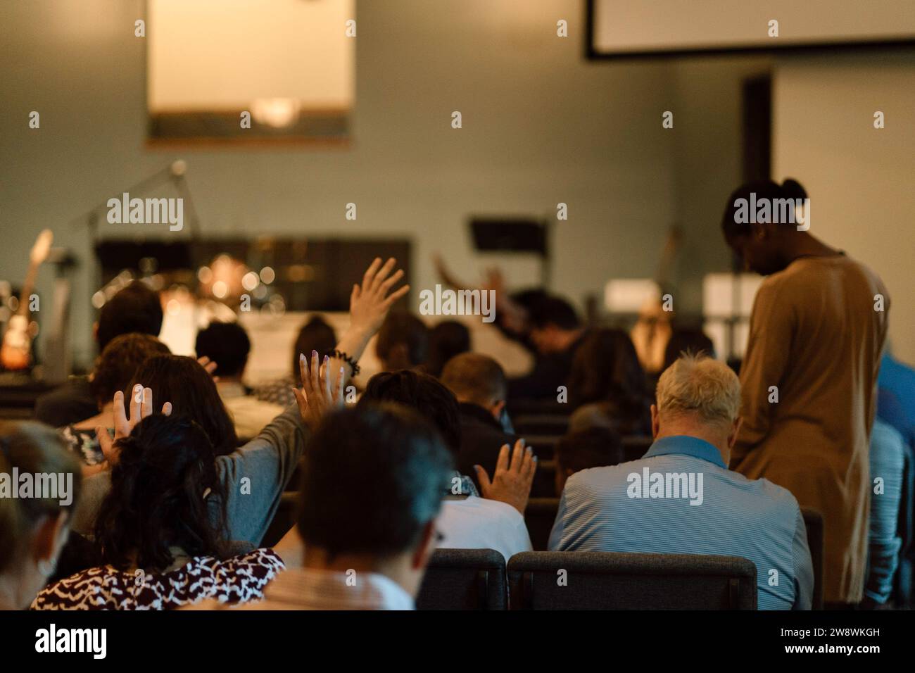 Raised hands in church service Stock Photo