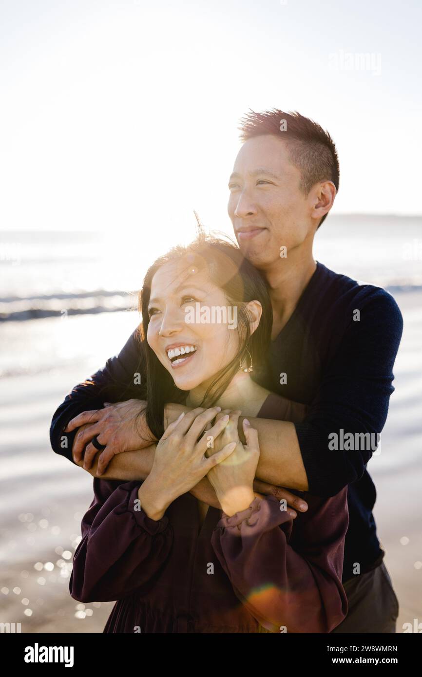 Asian Couple Posing on Beach at Sunset in San Diego Stock Photo