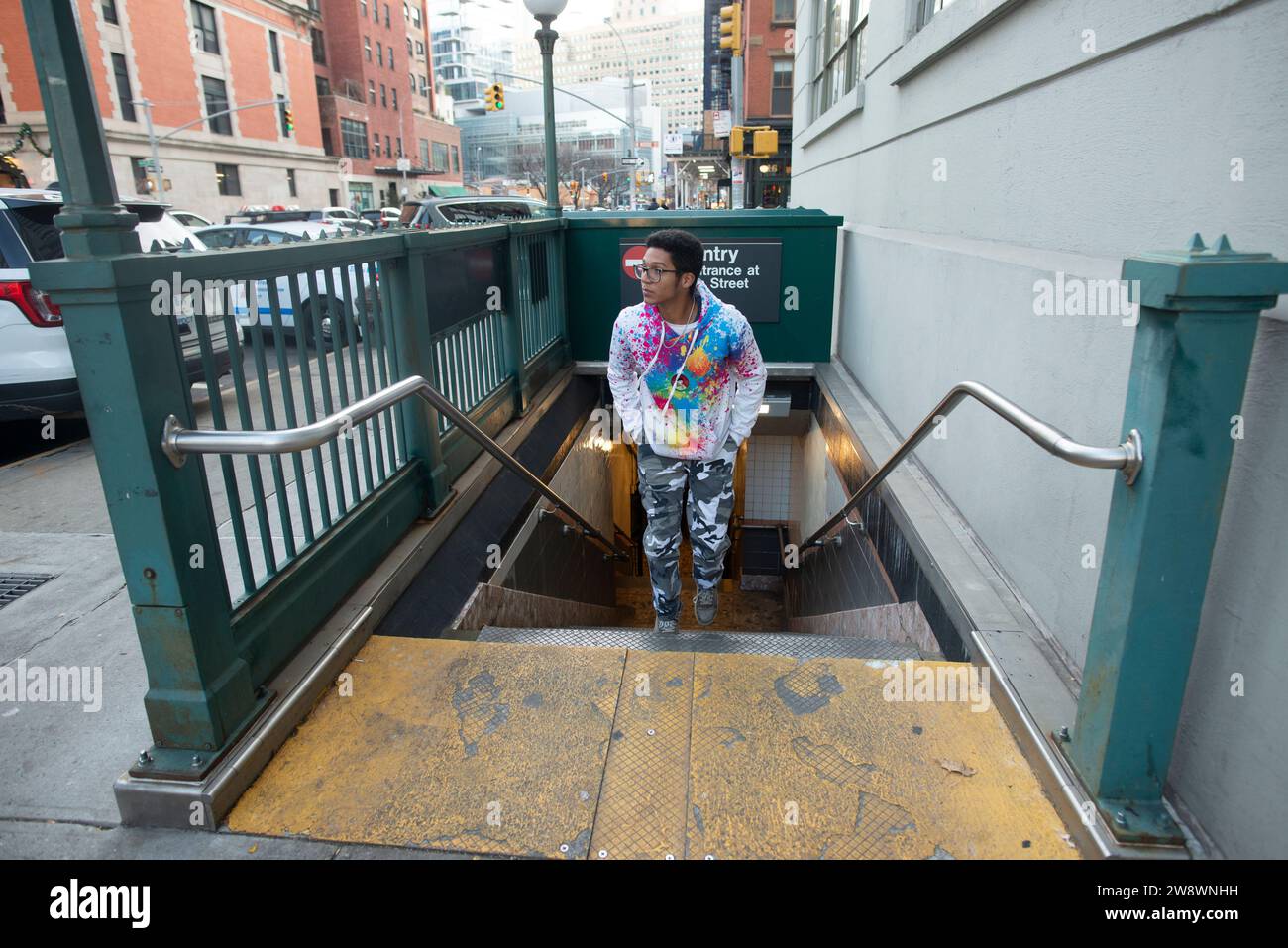 NYC Street Scene of young man coming out of subway Stock Photo