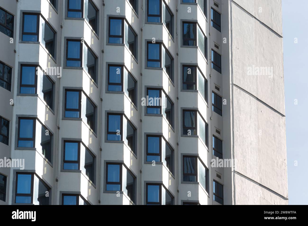 Closeup of multistory building with rows of windows. Stock Photo