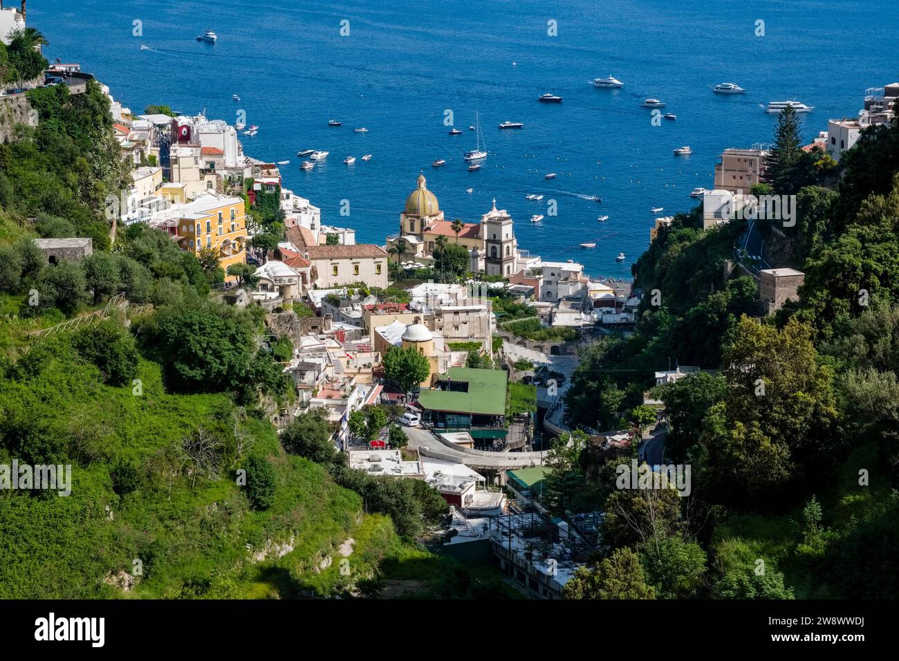 Aerial view of houses and the church Santa Maria Assunta of Positano on the Amalfi Coast, situated on a hill overlooking the Mediterranean Sea. Stock Photo