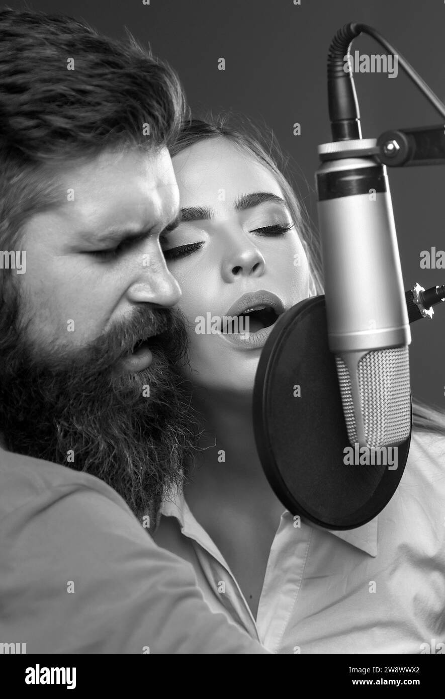 Couple in recording studio. Music performance vocal. Singer singing
