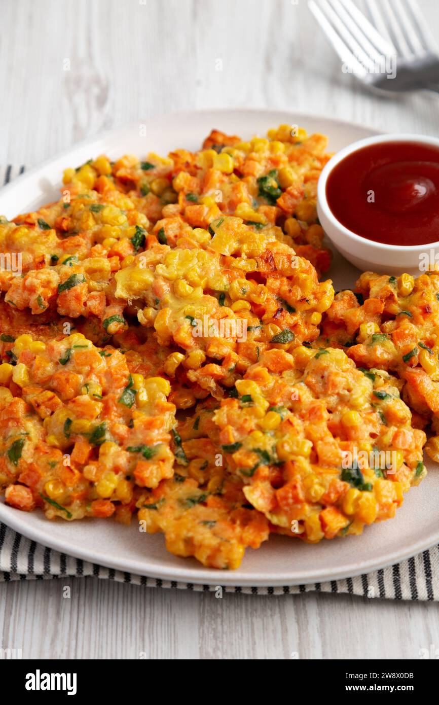 Homemade Carrot Corn Fritters with Ketchup on a Plate, side view Stock